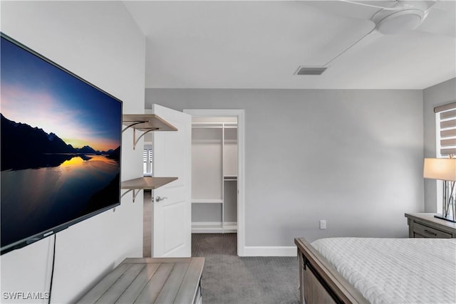 carpeted bedroom featuring ceiling fan, a closet, and a walk in closet