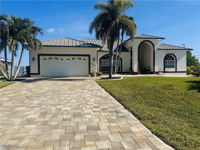 view of front of house featuring a garage and a front lawn