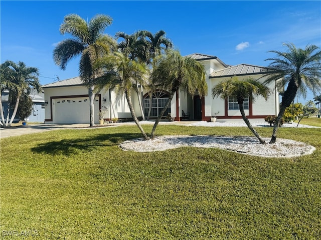 view of front of house featuring a front yard and a garage