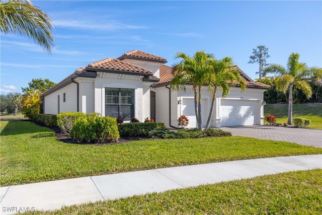 mediterranean / spanish house with a garage and a front yard