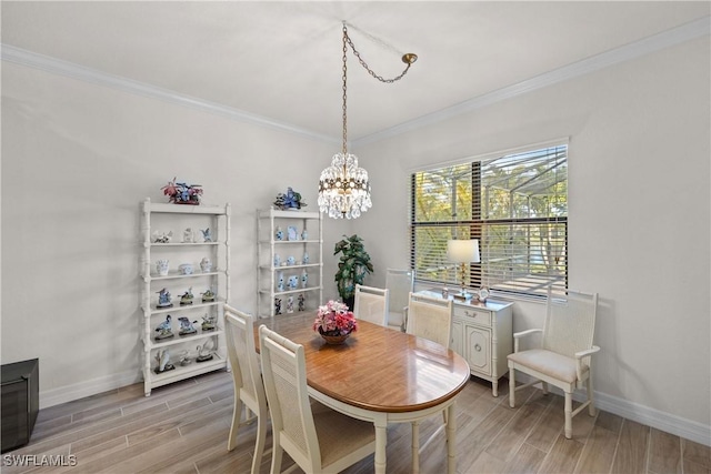 dining area featuring ornamental molding and a chandelier