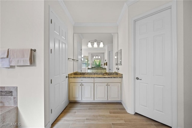 bathroom featuring vanity and ornamental molding