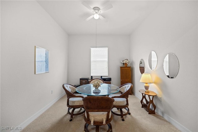 carpeted dining space with ceiling fan and a healthy amount of sunlight