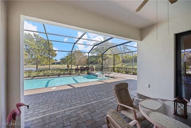 view of swimming pool featuring a lanai, a patio area, ceiling fan, and an in ground hot tub