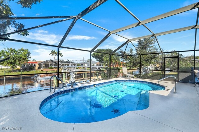 view of swimming pool featuring a water view, a patio, and a lanai