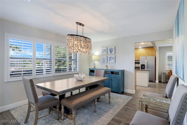 dining space featuring a chandelier and light hardwood / wood-style floors