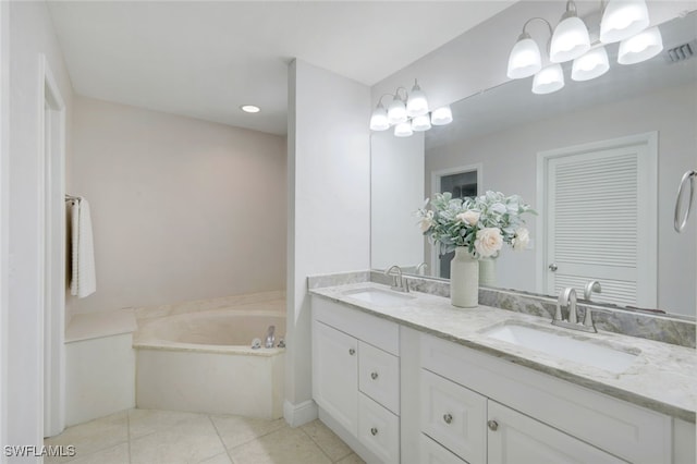 bathroom featuring tile patterned floors, vanity, and a bath