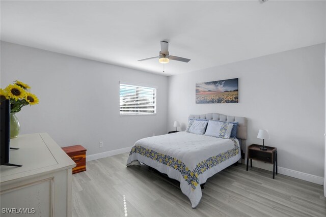 bedroom with light hardwood / wood-style flooring and ceiling fan