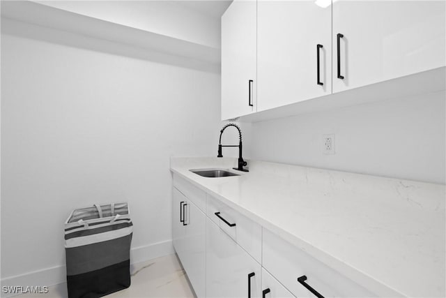 clothes washing area with sink