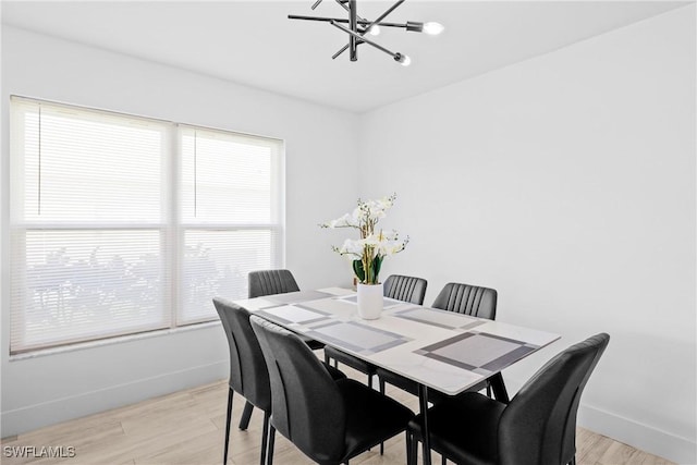 dining area with a chandelier and light hardwood / wood-style floors