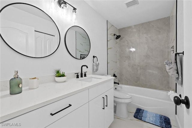 full bathroom featuring toilet, vanity, and tiled shower / bath