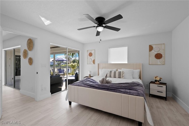 bedroom with ceiling fan, access to exterior, and light hardwood / wood-style floors