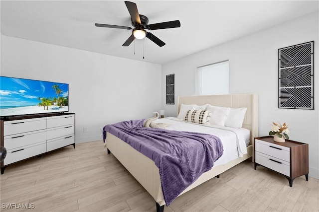 bedroom with ceiling fan and light hardwood / wood-style flooring