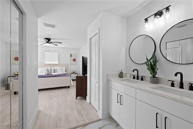 bathroom featuring ceiling fan, hardwood / wood-style floors, and vanity