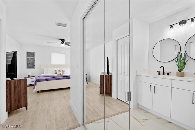 bathroom featuring ceiling fan and vanity