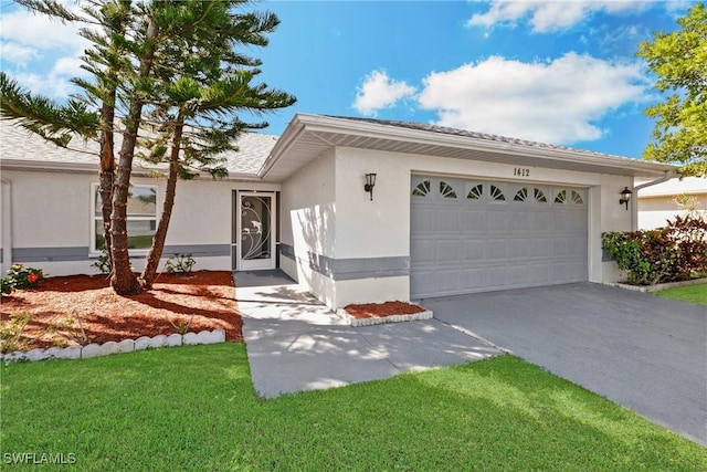 view of front of house featuring a front yard and a garage