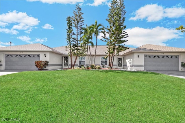 single story home featuring a garage and a front lawn