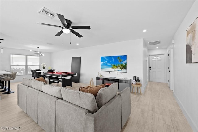 living room featuring billiards, ceiling fan with notable chandelier, and light hardwood / wood-style flooring