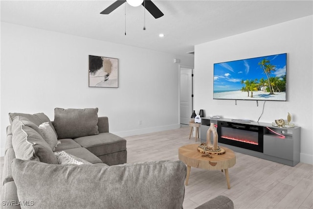 living room with ceiling fan and light hardwood / wood-style floors