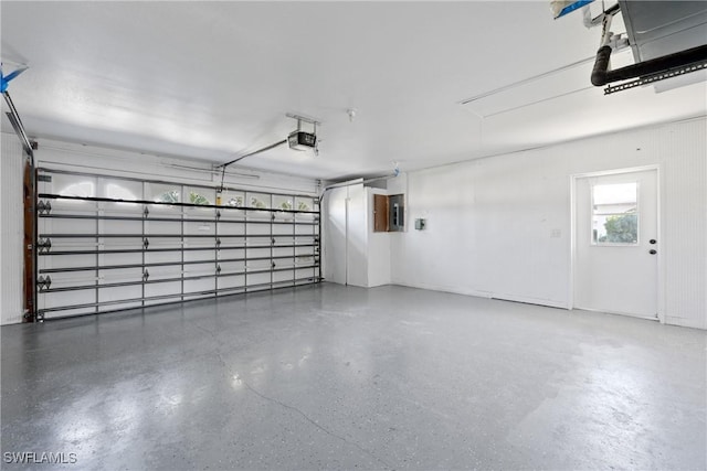 garage with electric panel and a garage door opener