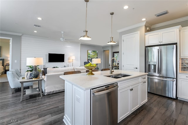 kitchen with a center island with sink, white cabinets, stainless steel appliances, and sink