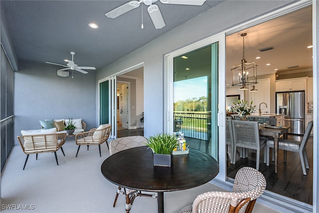 exterior space featuring ceiling fan with notable chandelier and sink