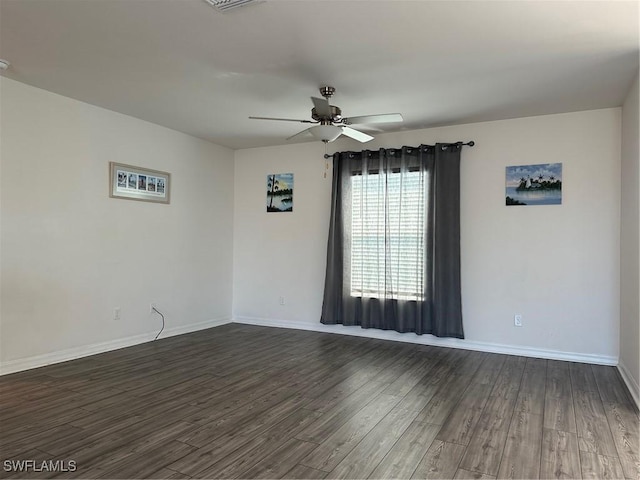 unfurnished room featuring ceiling fan and dark wood-type flooring