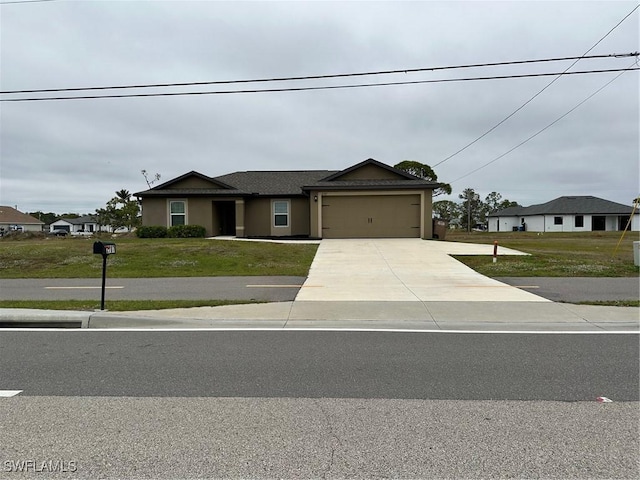 view of front of home with a front yard and a garage