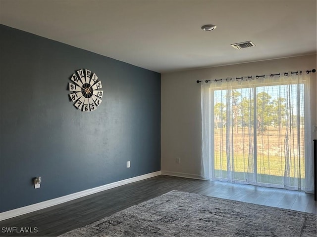 unfurnished room featuring dark hardwood / wood-style floors