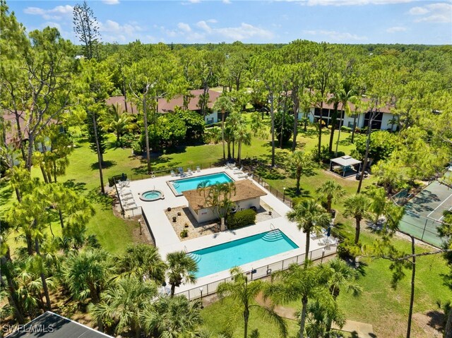 drone / aerial view featuring a wooded view