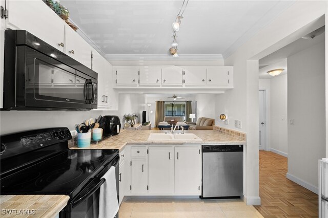 kitchen with crown molding, light countertops, white cabinets, a sink, and black appliances