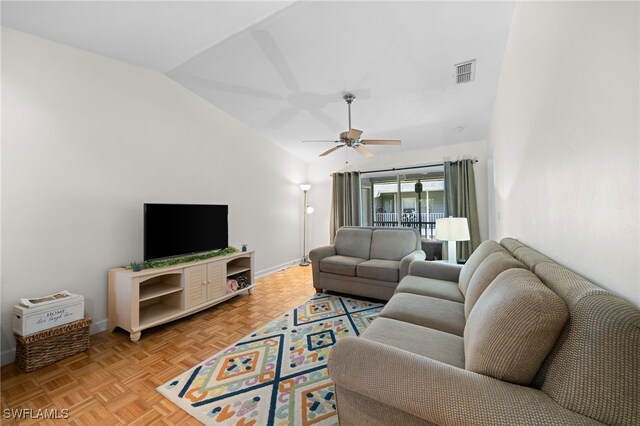 living room featuring ceiling fan, vaulted ceiling, and light parquet flooring