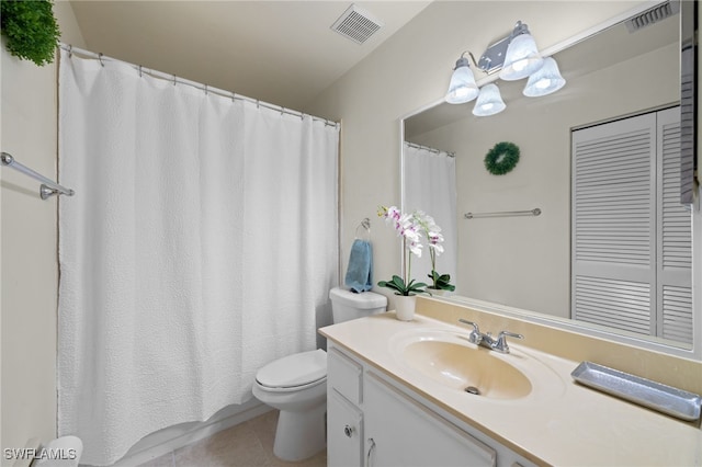 bathroom with toilet, vanity, visible vents, and tile patterned floors