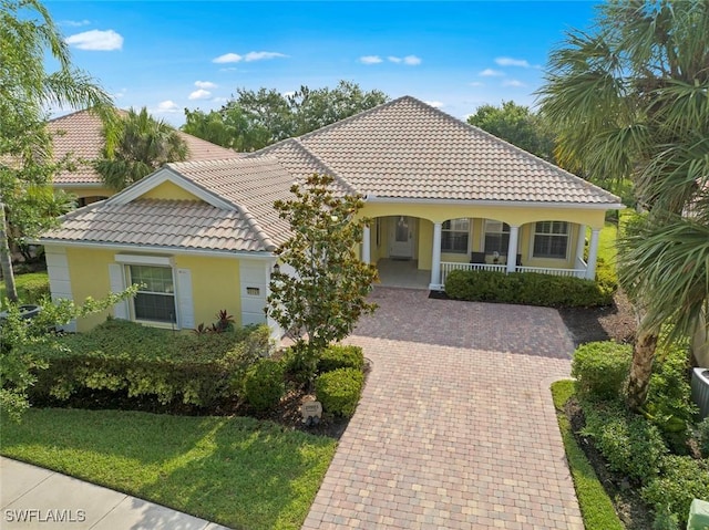 mediterranean / spanish house with covered porch