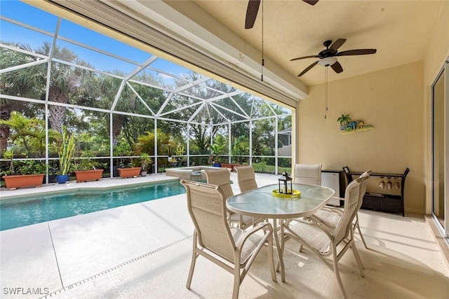 view of swimming pool featuring ceiling fan, glass enclosure, an in ground hot tub, and a patio