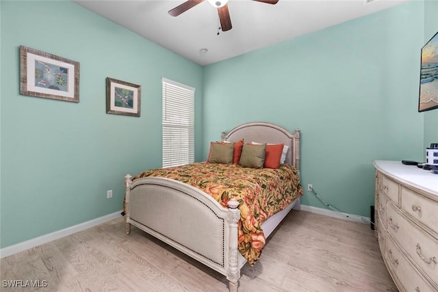 bedroom with ceiling fan and light hardwood / wood-style flooring