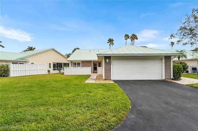 ranch-style home featuring a front lawn and a garage