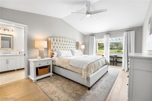 bedroom with connected bathroom, vaulted ceiling, light hardwood / wood-style floors, ceiling fan, and sink