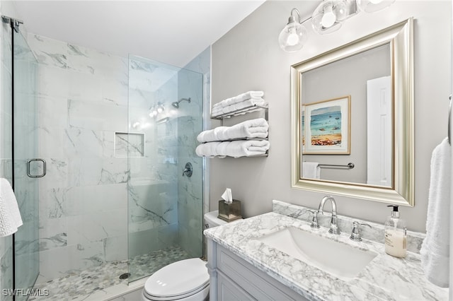 bathroom featuring walk in shower, vanity, and toilet