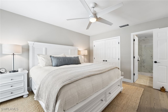 bedroom featuring ceiling fan, light hardwood / wood-style flooring, connected bathroom, and a closet