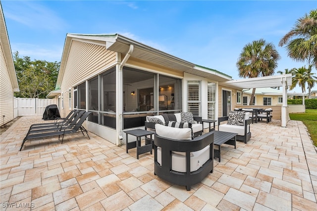 view of patio with a sunroom and outdoor lounge area