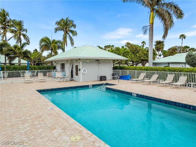 view of pool featuring a patio and central AC