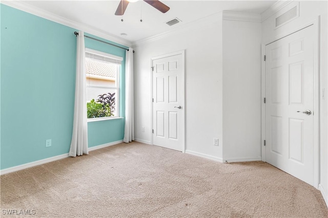 unfurnished bedroom with ceiling fan, light carpet, and ornamental molding