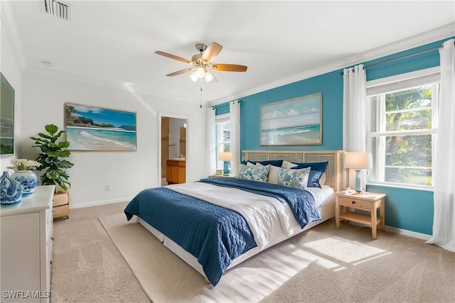 carpeted bedroom featuring ensuite bath, ceiling fan, and ornamental molding