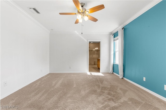 carpeted spare room featuring ceiling fan and crown molding