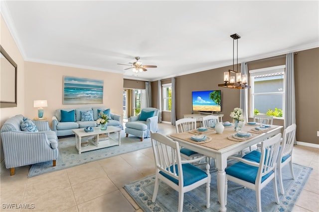 tiled dining space with ceiling fan with notable chandelier and crown molding