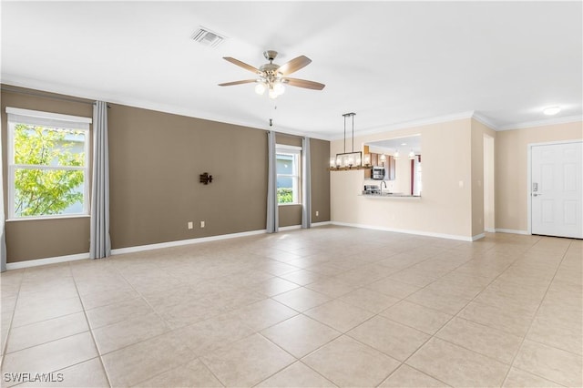 unfurnished room with crown molding, light tile patterned floors, and ceiling fan with notable chandelier