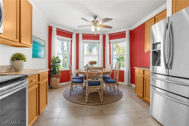 kitchen with appliances with stainless steel finishes, ceiling fan, and ornamental molding