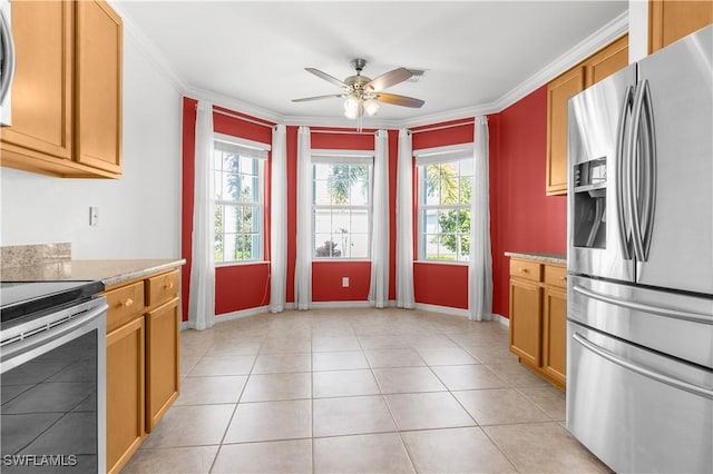 kitchen with light stone countertops, ceiling fan, stainless steel appliances, crown molding, and light tile patterned flooring