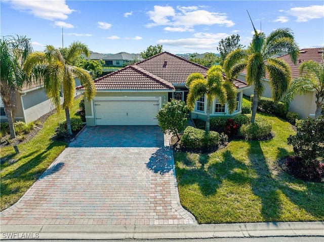 mediterranean / spanish house with a garage and a front yard